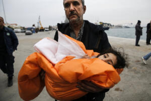 A Syrian refugee carries his daughter covered with a blanket, after being rescued at open sea, as they arrive at the port of Mytilene on the Lesbos island, Greece, March 22, 2016. REUTERS/Alkis Konstantinidis TPX IMAGES OF THE DAY