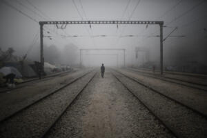 epa05601629 YEARENDER 2016 APRIL A refugee walks on the train tracks amidst morning mist at a refugee camp near the Greek-FYROM border near the village of Idomeni, northern Greece, 04 April 2016. The vessels 'Nazli Jale' and 'Lesvos' chartered by Frontex mission left Mytilene on early 04 April with 136 refugees on board - most of them from Pakistan - as part of the EU-Turkey agreement for the return of refugees to Turkey. Refugees were accompanied by an equal number of Frontex policemen in order to ensure their safe transfer to Dikili port. EPA/KOSTAS TSIRONIS